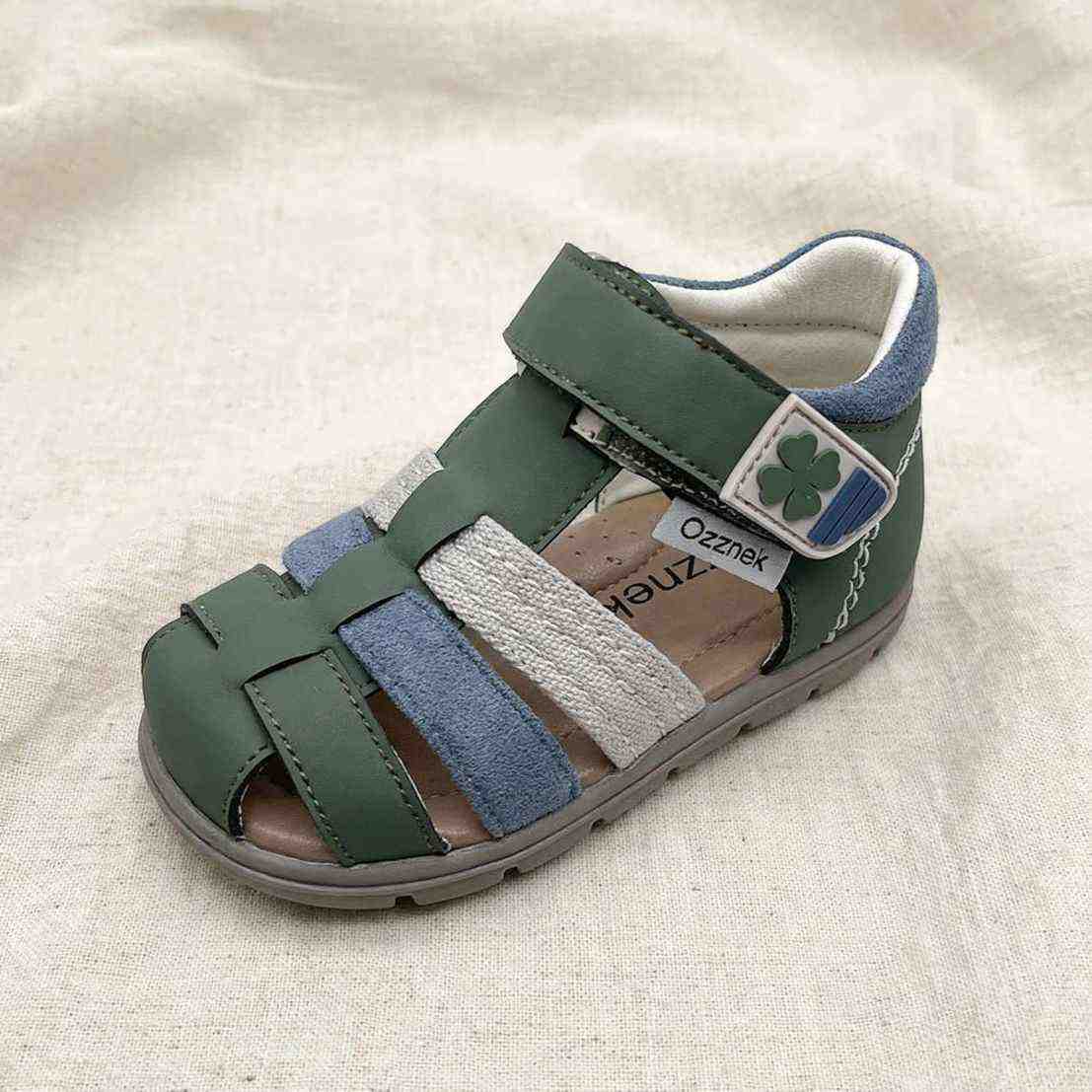 Clover Green Barefoot Toddler Sandals – Comfortable and Stylish on cream linen background