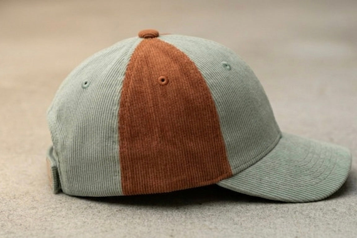Side view of Ozznek toddler corduroy hat in Sage and Rust showing the leather logo patch