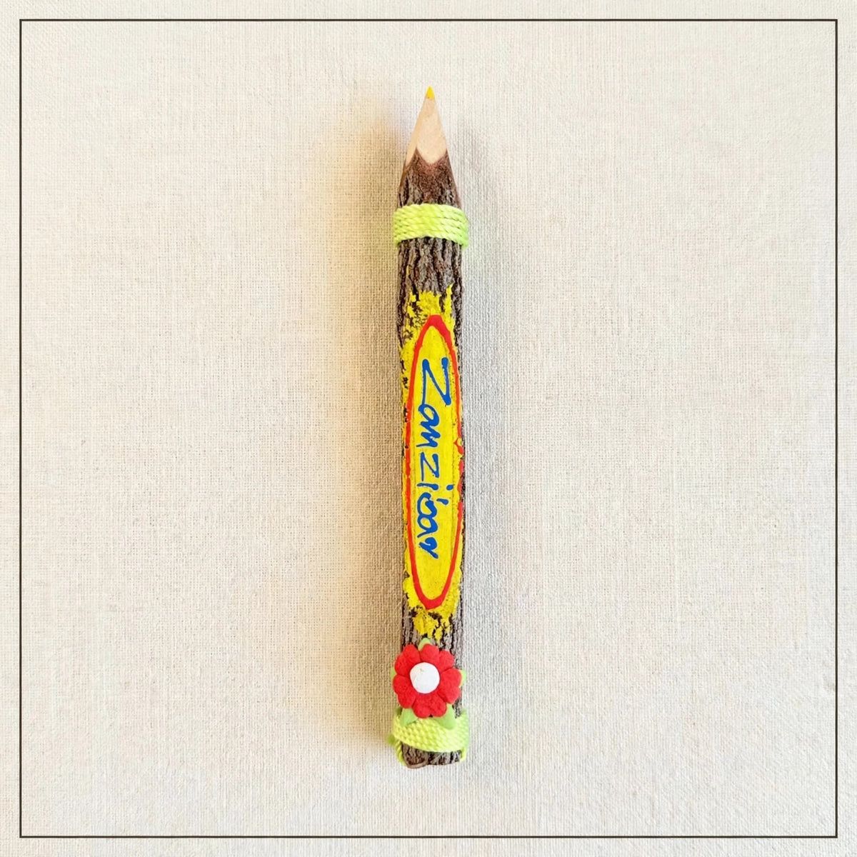 Big yellow hand-carved wooden coloring pencil with the hand-painted word Zanzibar, yellow tip