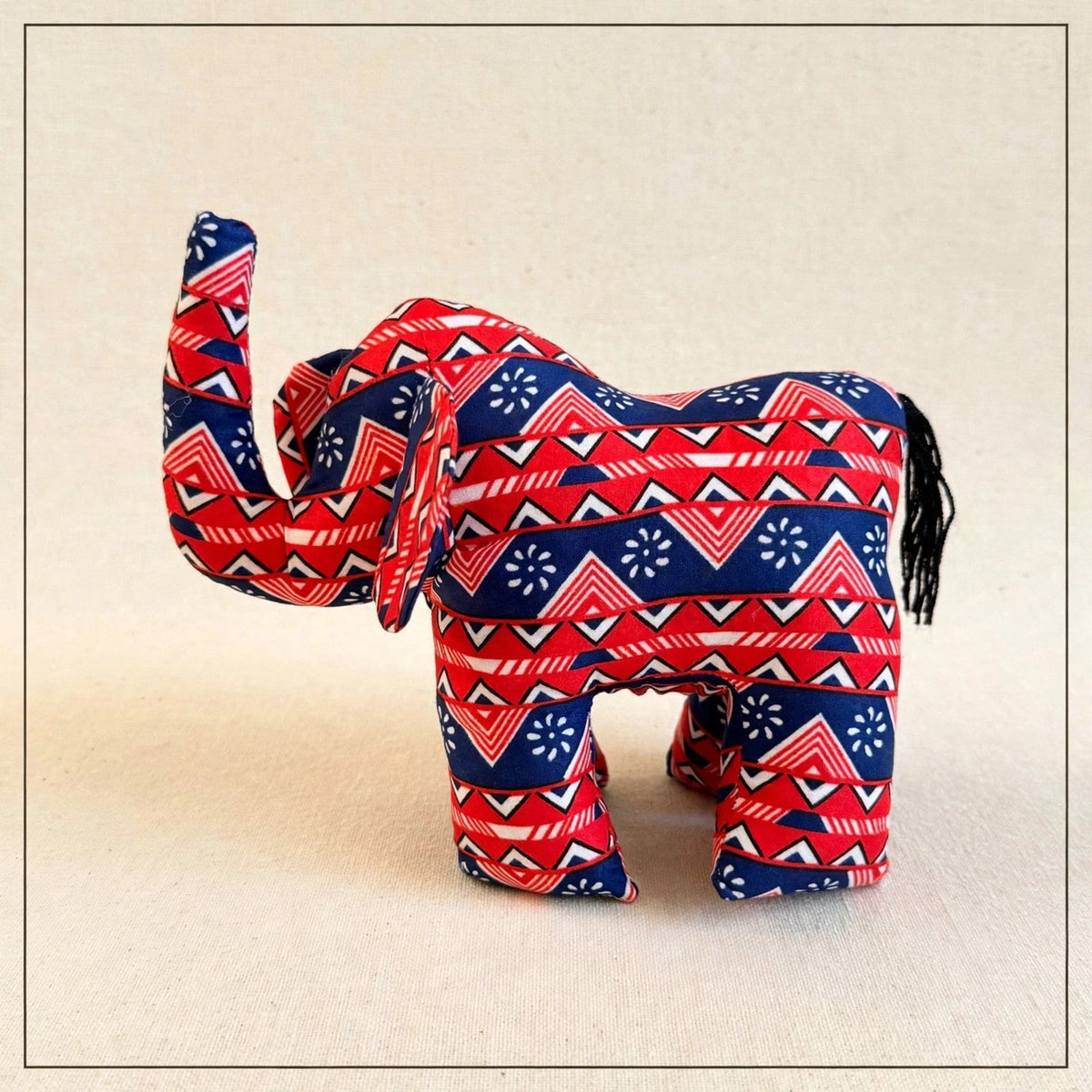 Handmade African kente fabric elephant plush from Zanzibar, Tanzania - one of a kind stuffed animal gift for kids