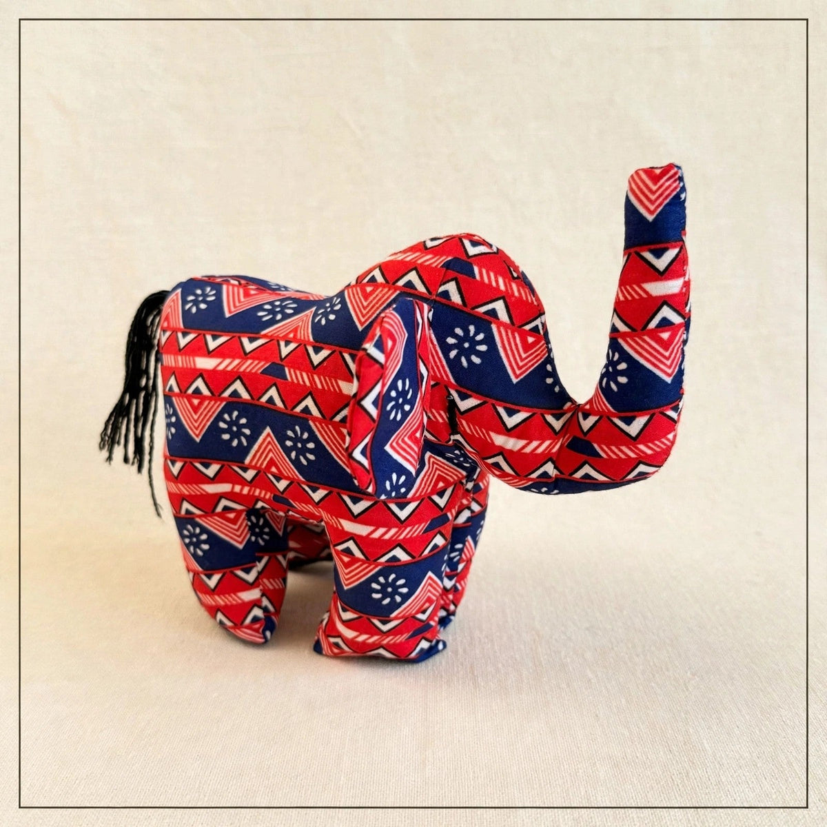Handmade African kente fabric elephant plush from Zanzibar, Tanzania - one of a kind stuffed animal gift for kids