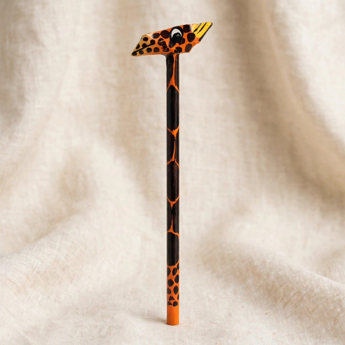 Hand-carved wooden pencil with an orange leopard head, second view