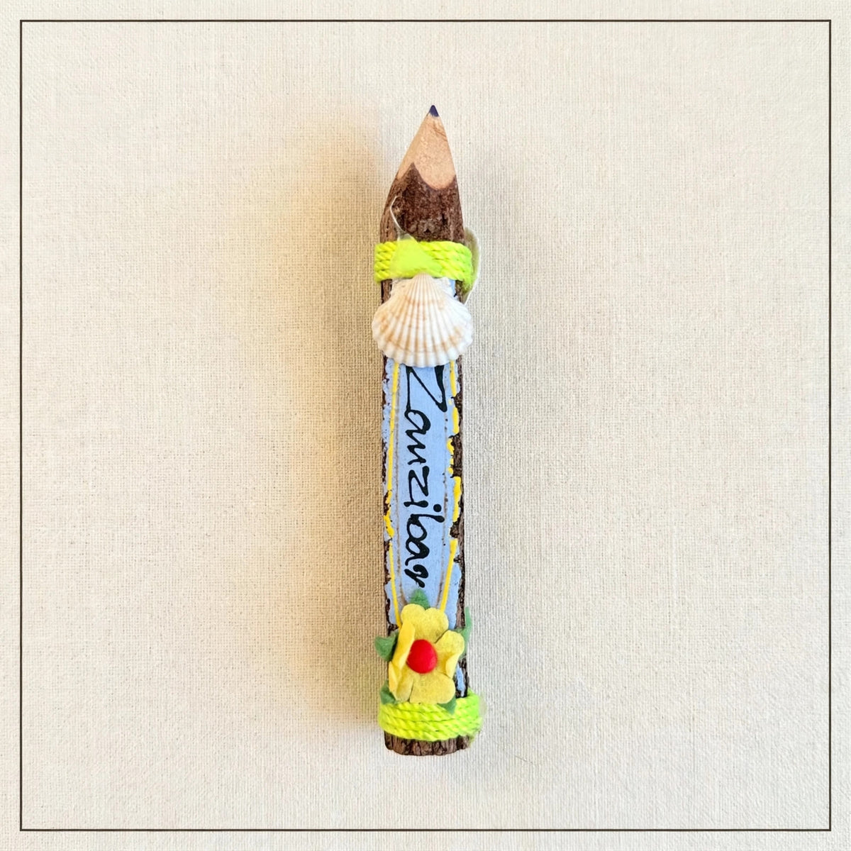 Small blue hand-carved wooden coloring pencil with a real seashell and the hand-painted word Zanzibar
