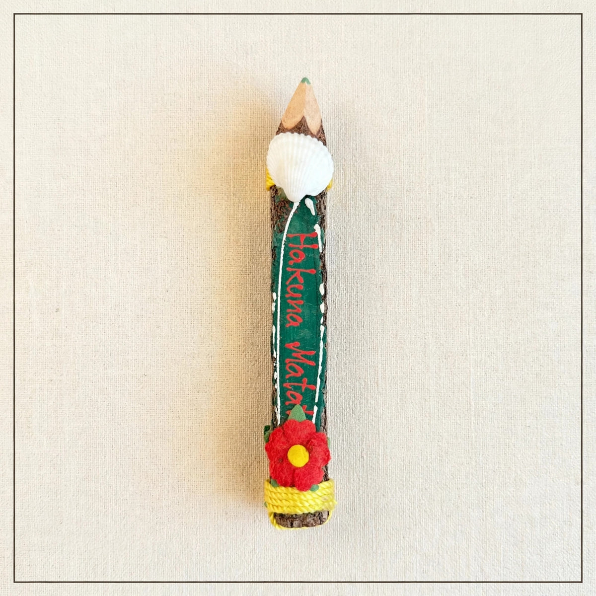 Small hand-carved wooden coloring pencil with a real seashell and the hand-painted Swahili words Hakuna Matata