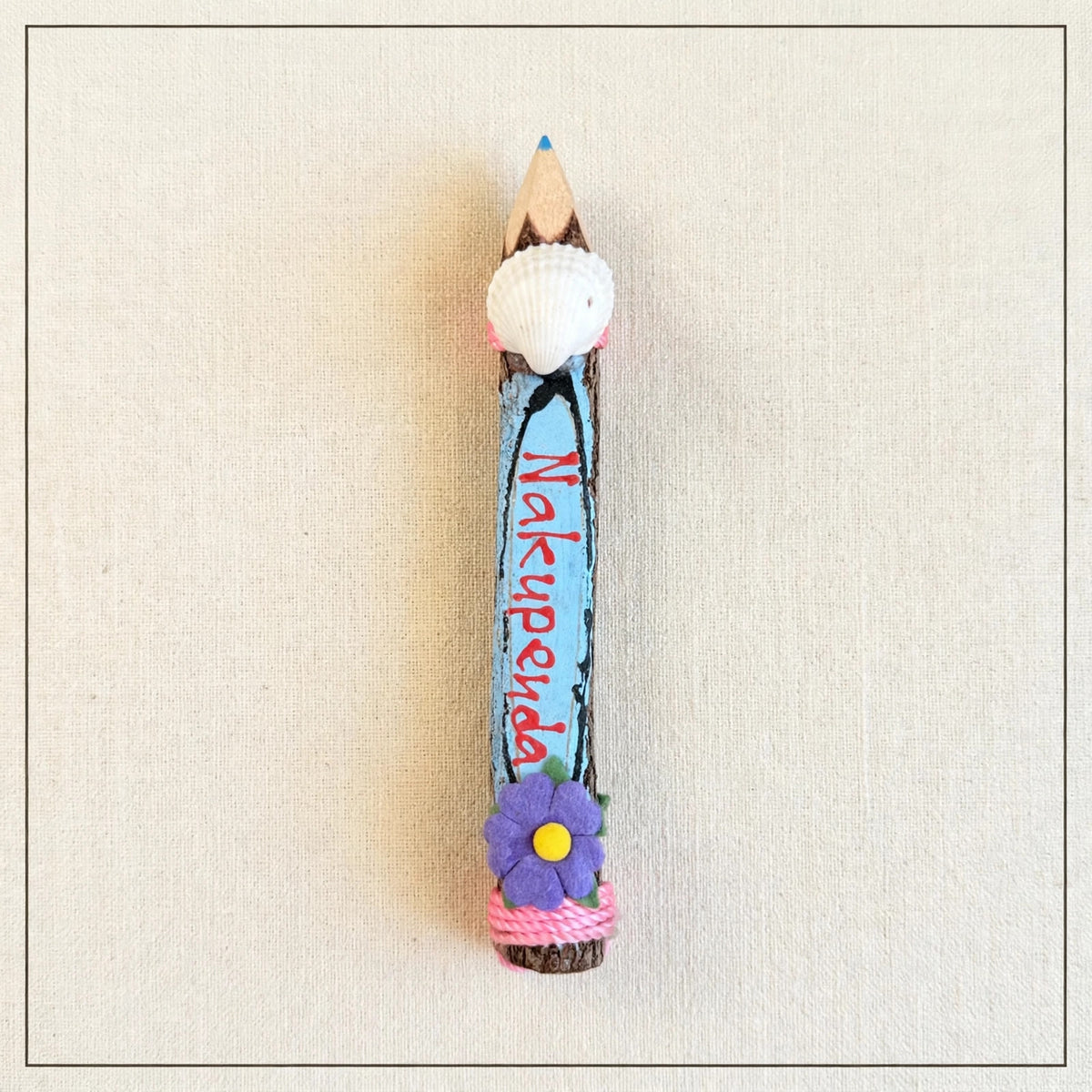 Small hand-carved wooden coloring pencil with a real seashell and the hand-painted Swahili word Nakupenda