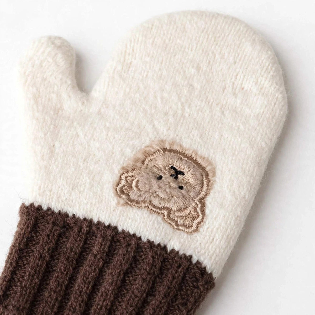 Winter mittens bear embroidery detail - white studio photo